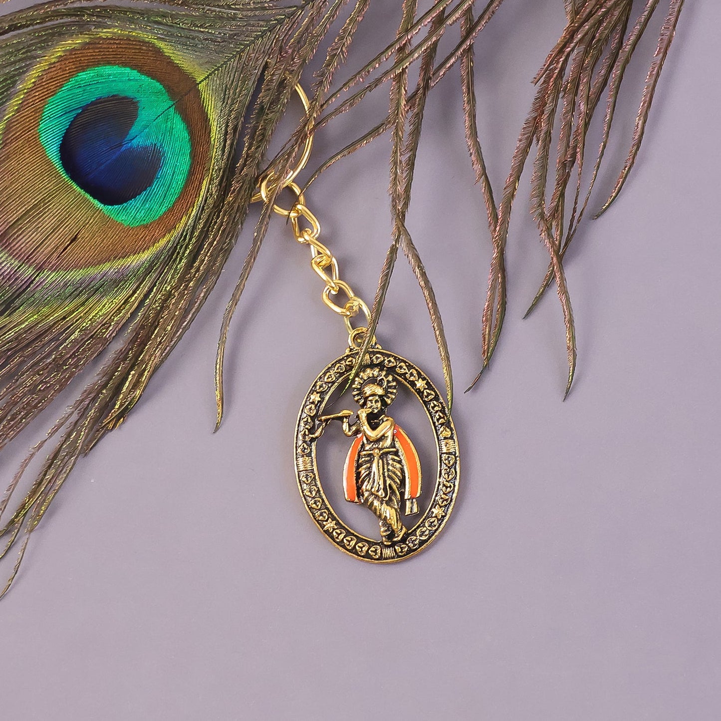Close-up showing detailed engravings on Lord Krishna metal keychain