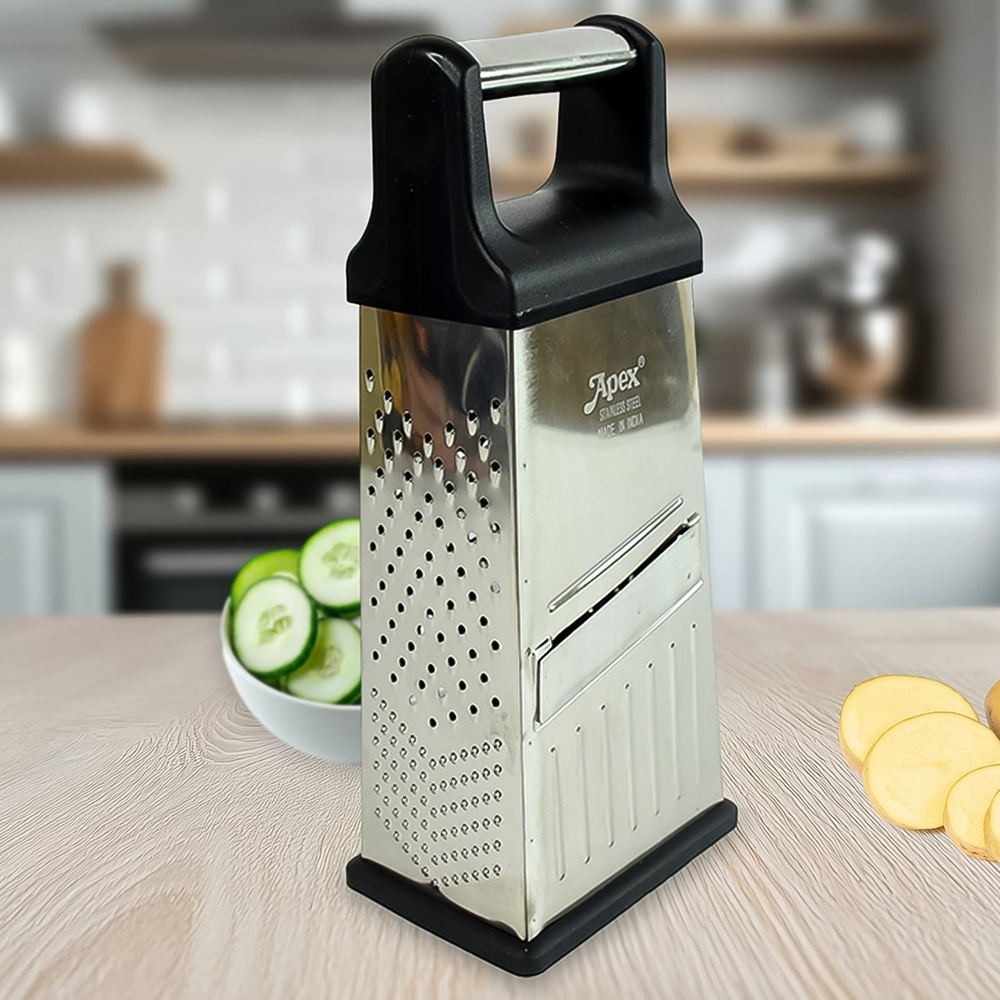 Apex 5-in-1 stainless steel slicer and grater in use grating vegetables