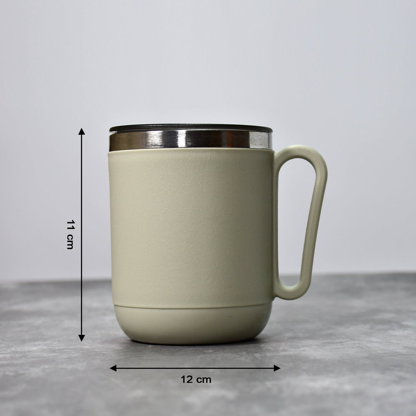 An Indian man enjoying a hot beverage from the Ganesh stainless steel coffee mug.