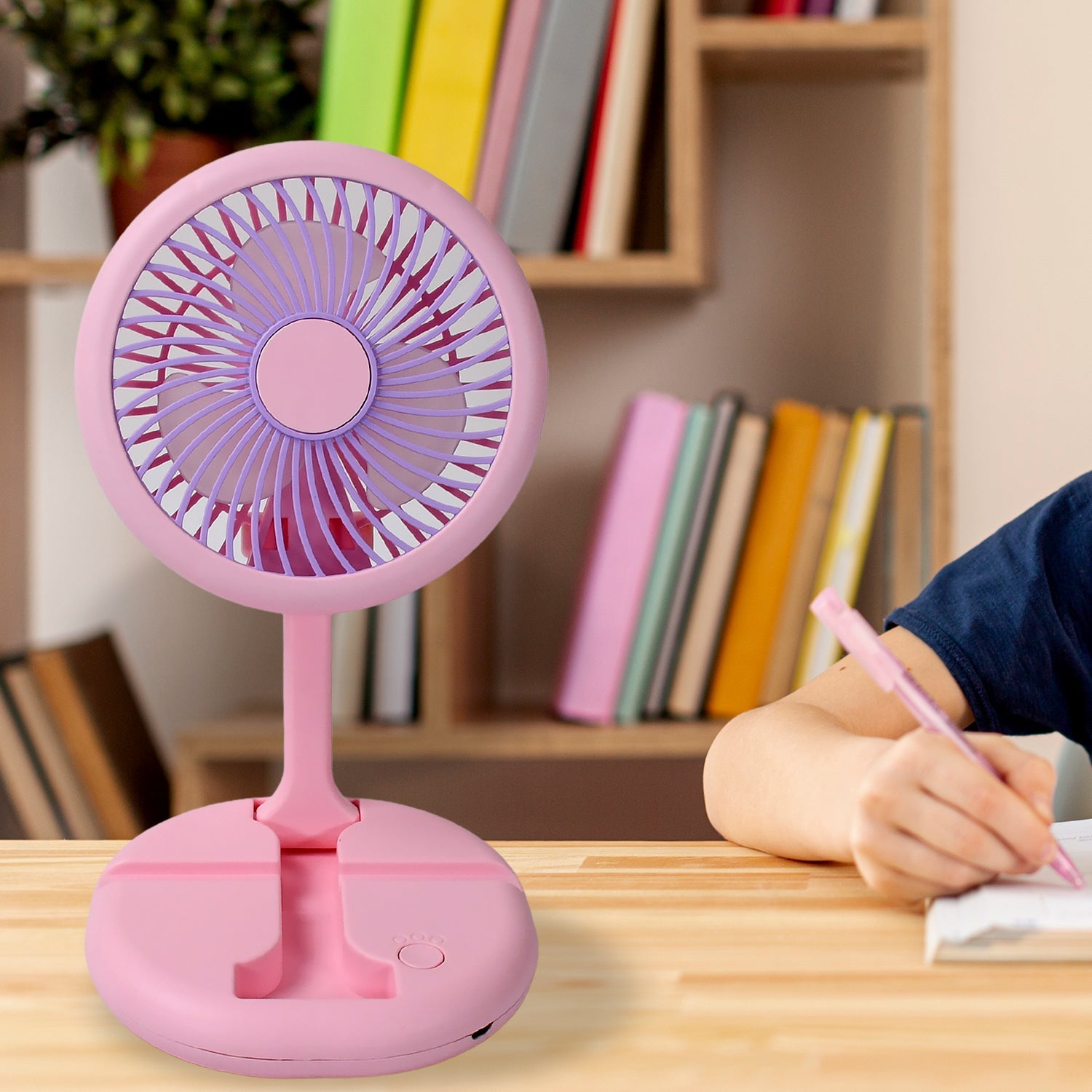 The portable fan in use, providing a cool breeze to a person working outdoors.