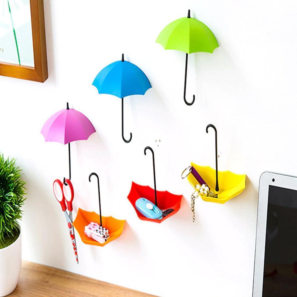 Colourful umbrella key holder mounted on a white wall, showcasing its vibrant design.