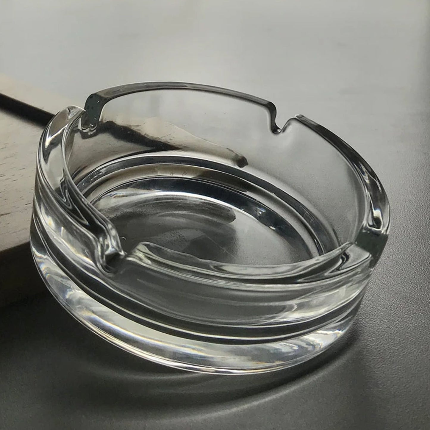 Durable crystal glass ashtray suitable for both indoor and outdoor use.