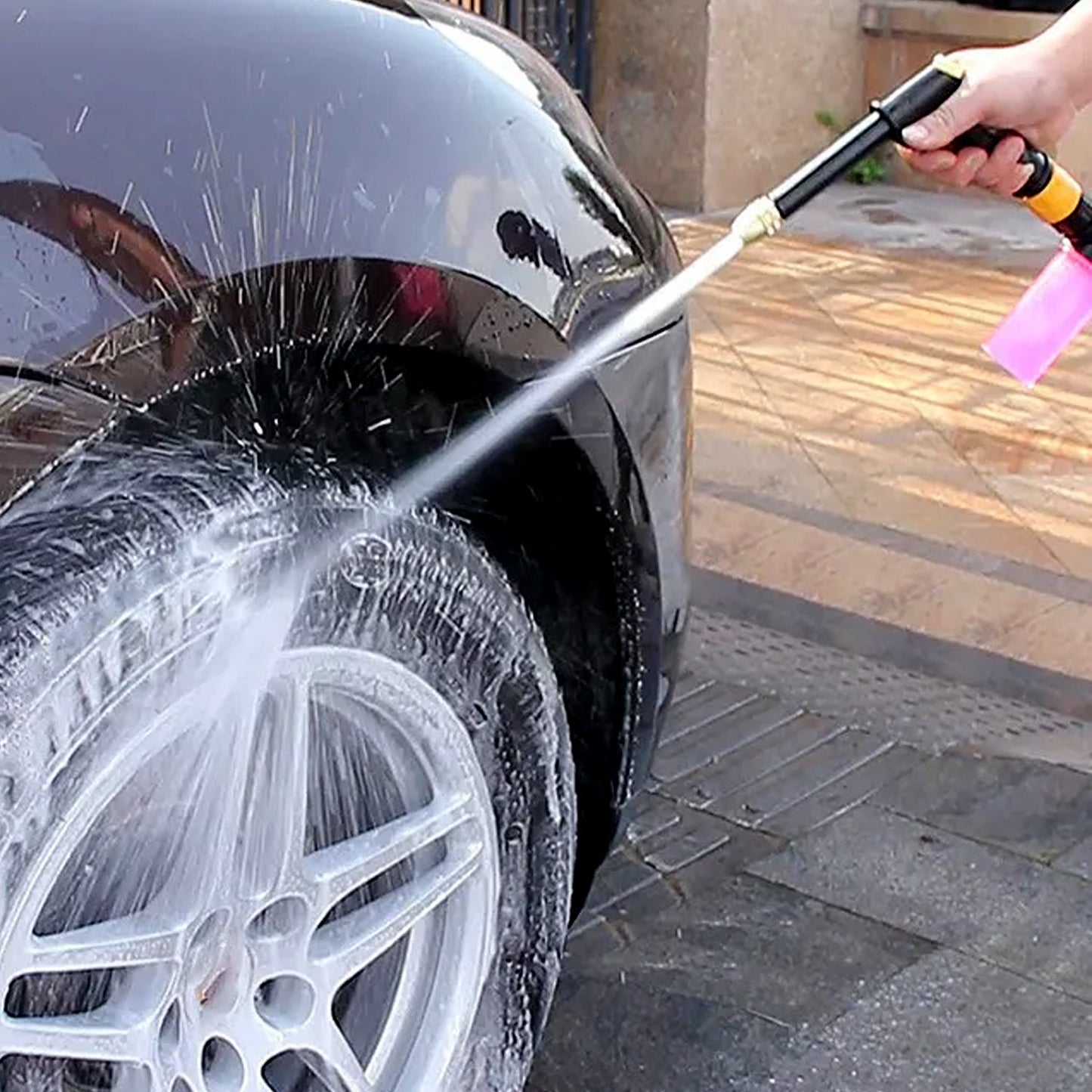 Hand rotating the multi-mode brass spray gun nozzle to select different water patterns.
