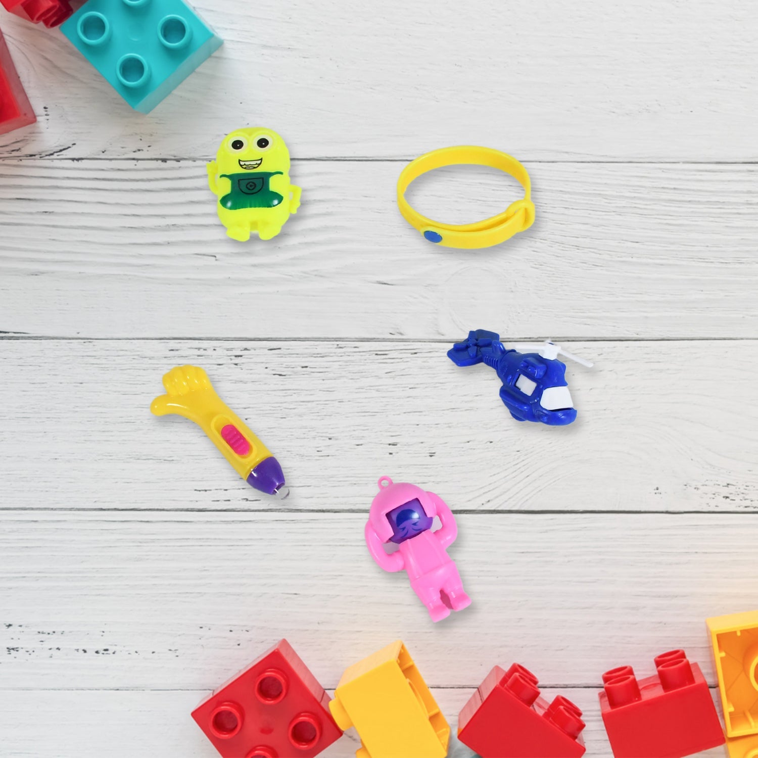 Colorful Kids Toy Combo with a soldier, rattle, and other toys, presented in a traditional Potli bag.