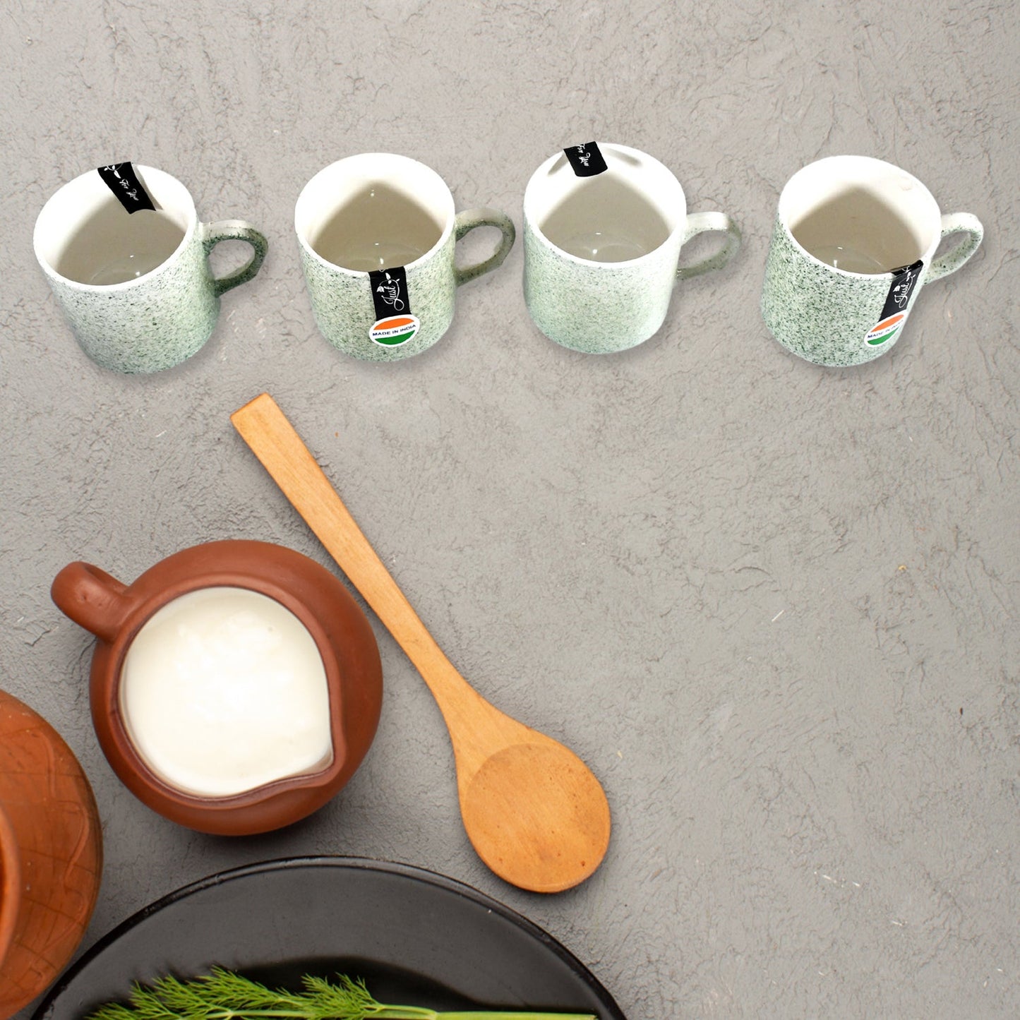 An overhead view of the Serve Stellar 6-piece serving set, emphasizing the coordinated design of the ceramic cups and plastic platter.