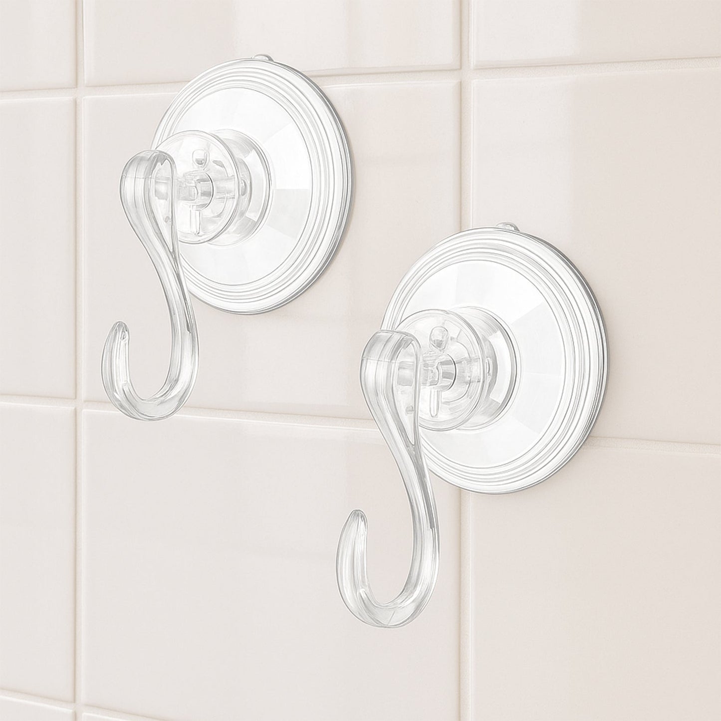 Four plastic suction cup hooks arranged for hanging items