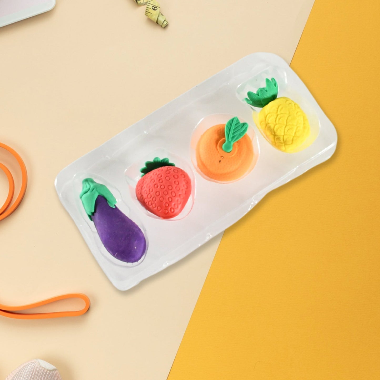 Pack of 4 small, cute fruit and vegetable erasers, ideal for kids' stationery.