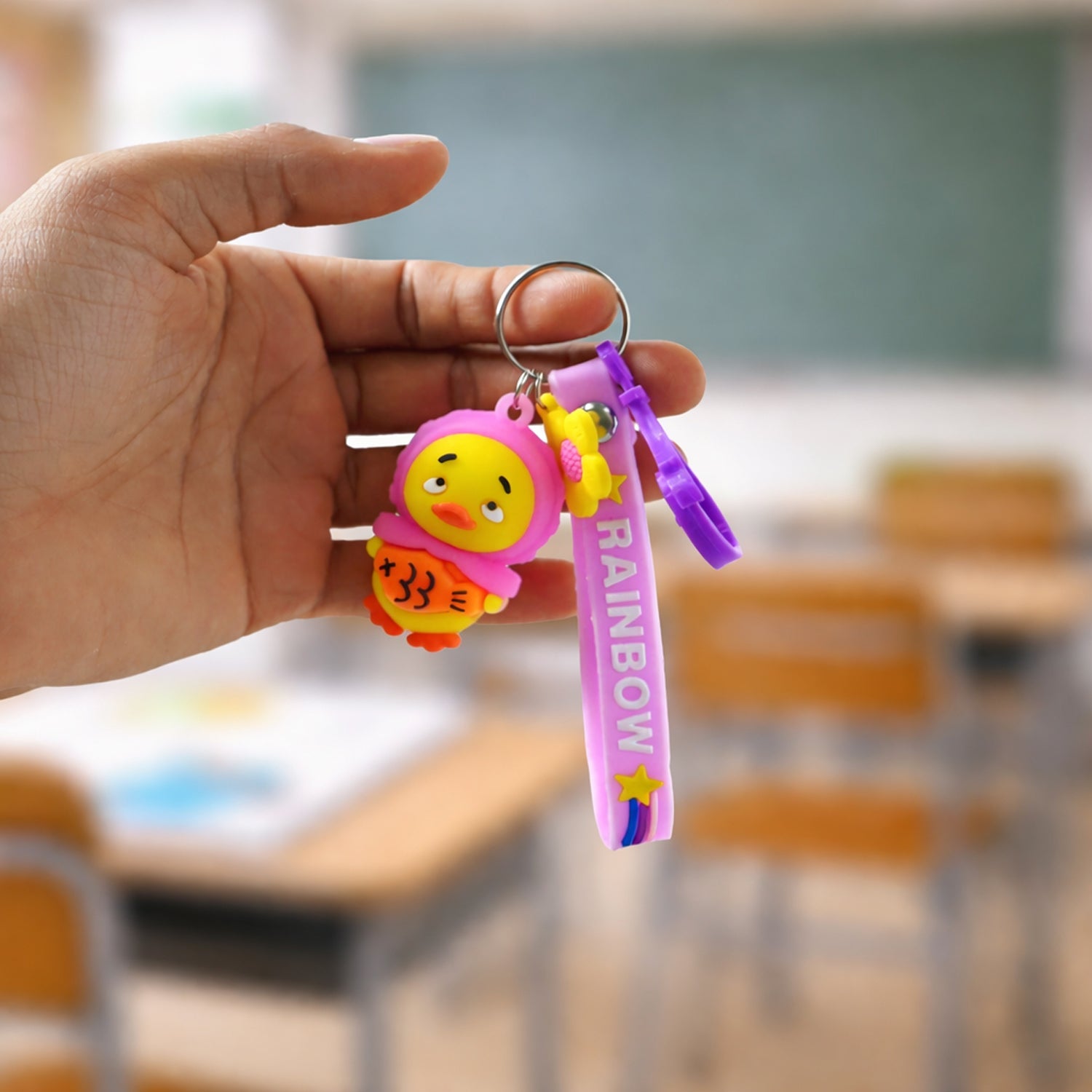 Side view of the cute rainbow strap cartoon duck silicone keychain for kids