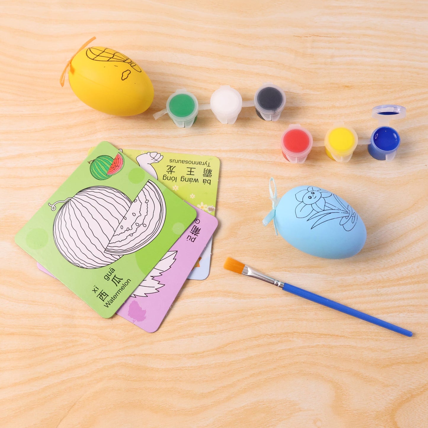 Children using creative painting set with colour cards and paint pots