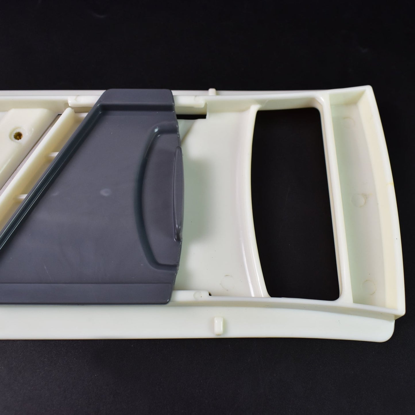 Sharp stainless steel blade of the slicer, ready for effortless vegetable slicing.