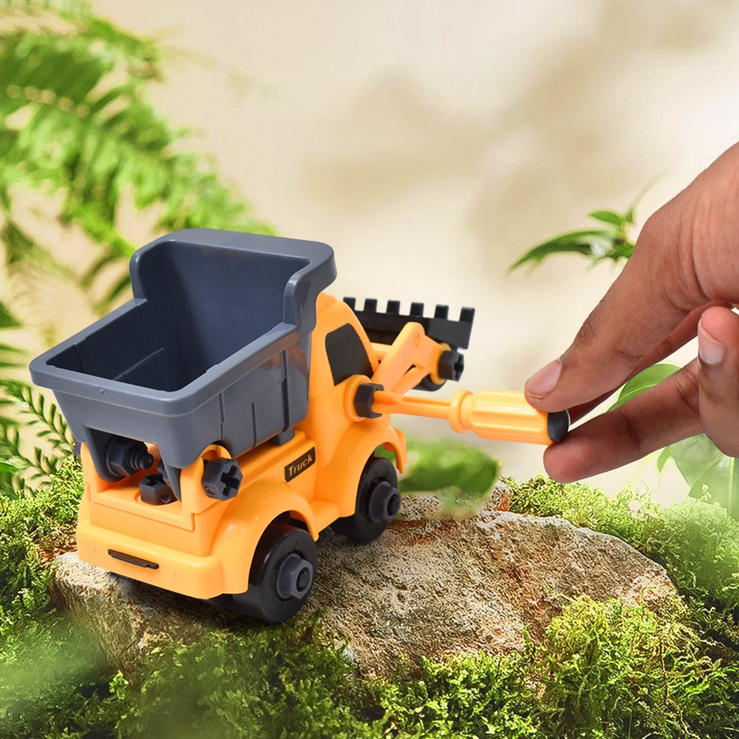 A young boy focused on building his DIY construction set vehicle.