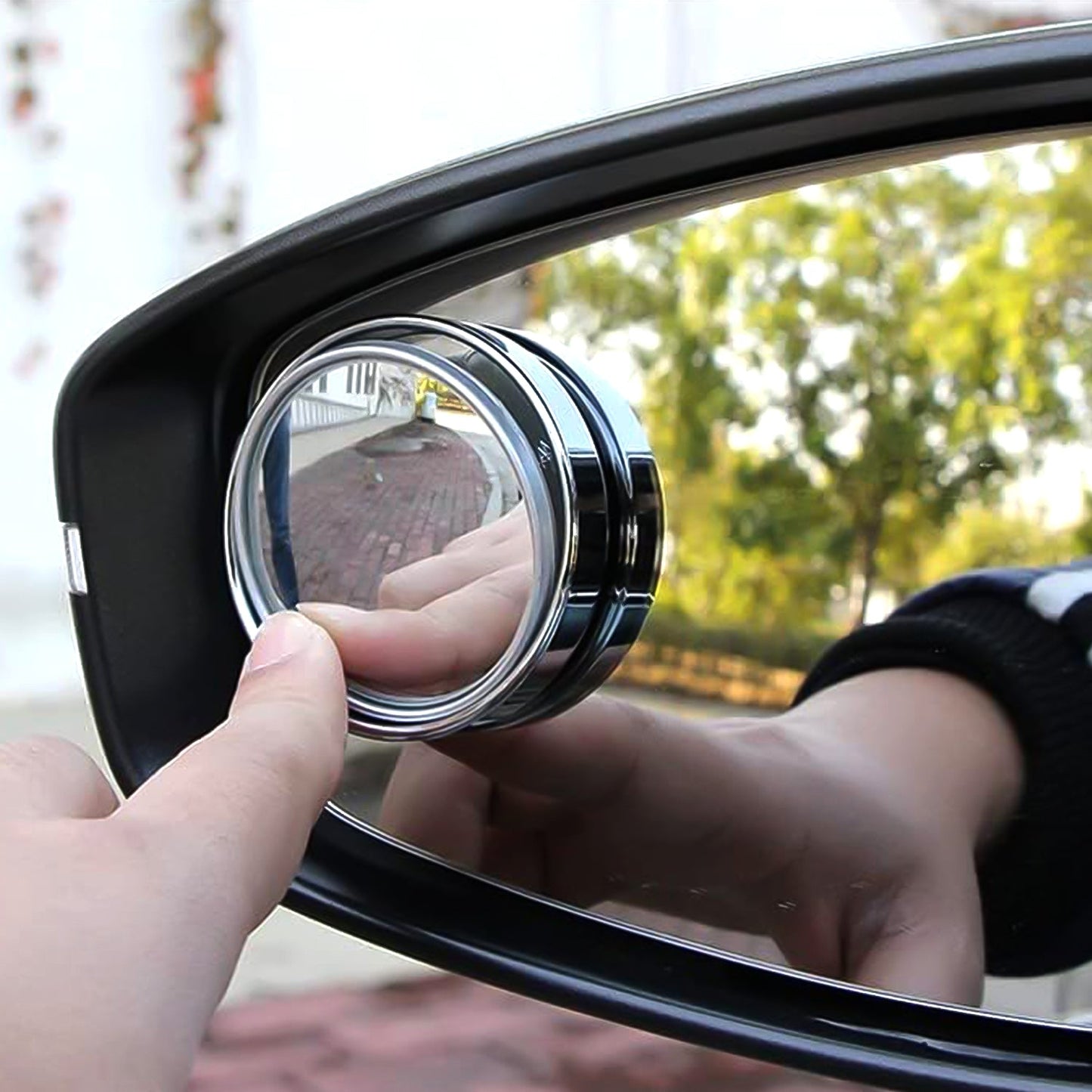 Close-up of round blind spot mirror on car