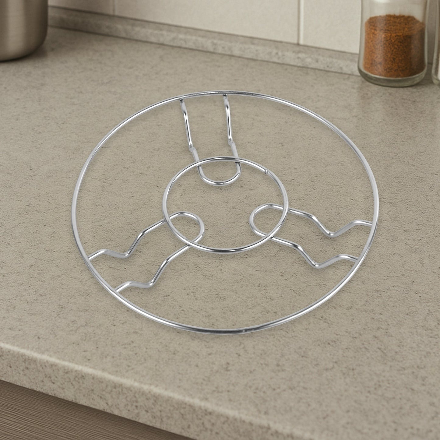 Stainless steel trivet set laid out on wooden dining table