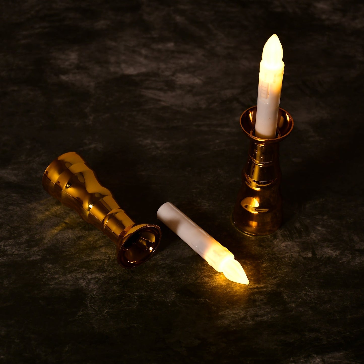 Close-up of a flameless LED candle light showing its realistic flicker and elegant gold base.