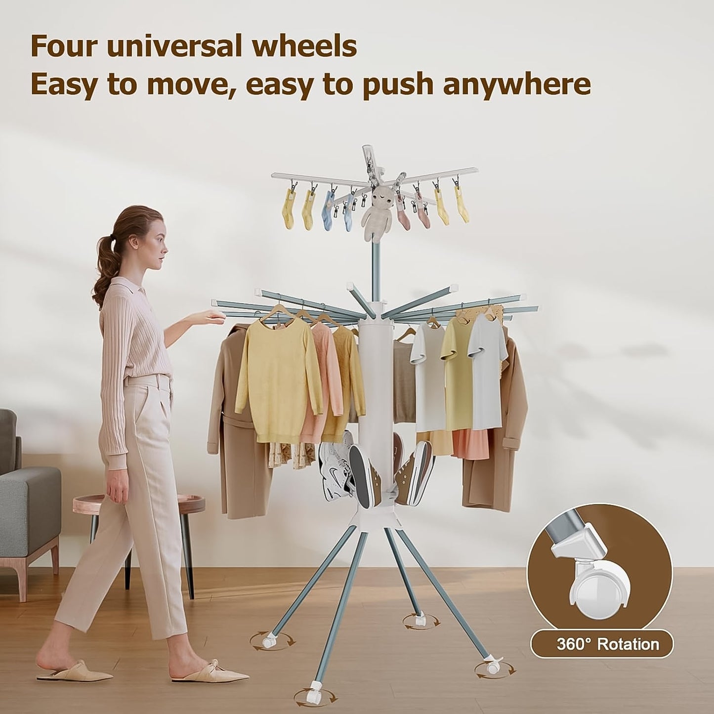 Clothes drying rack in use with multiple hanging garments drying