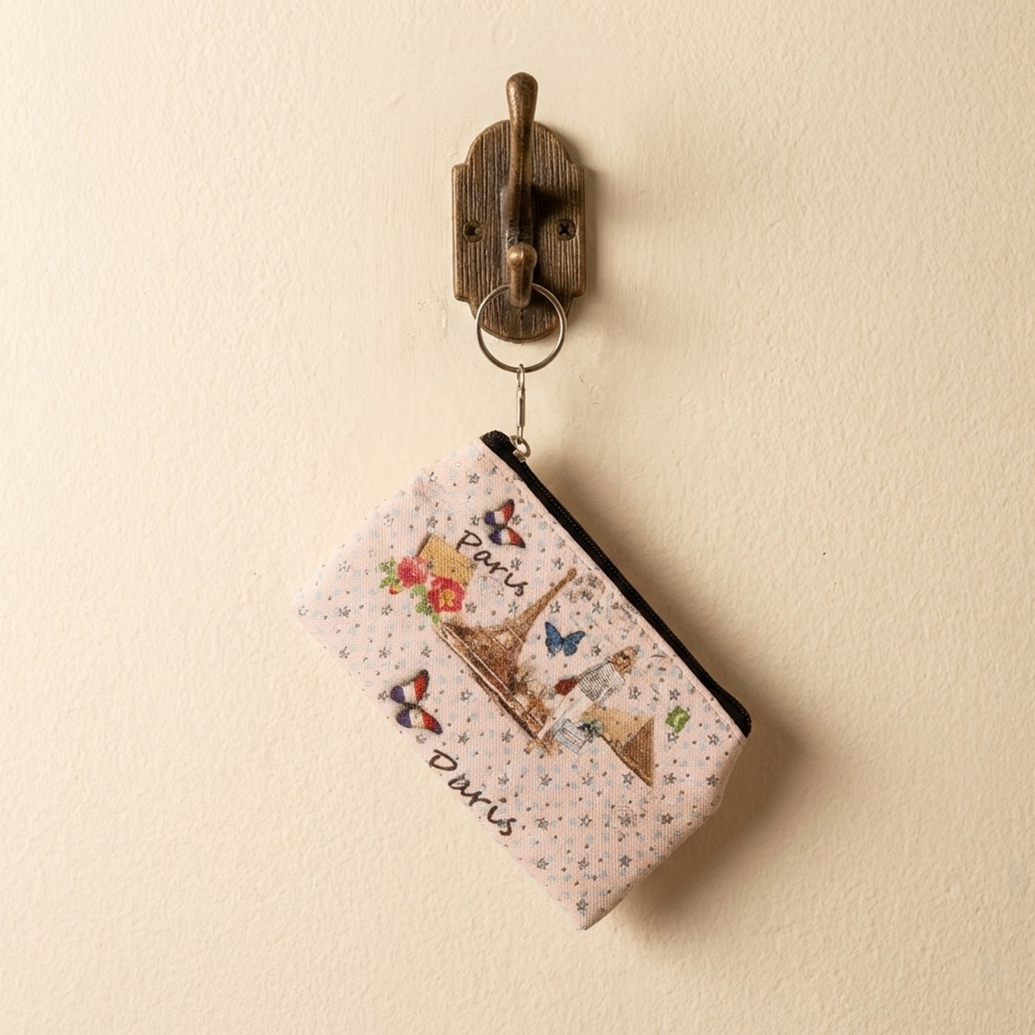 Compact coin pouch with a secure zip closure and Paris print