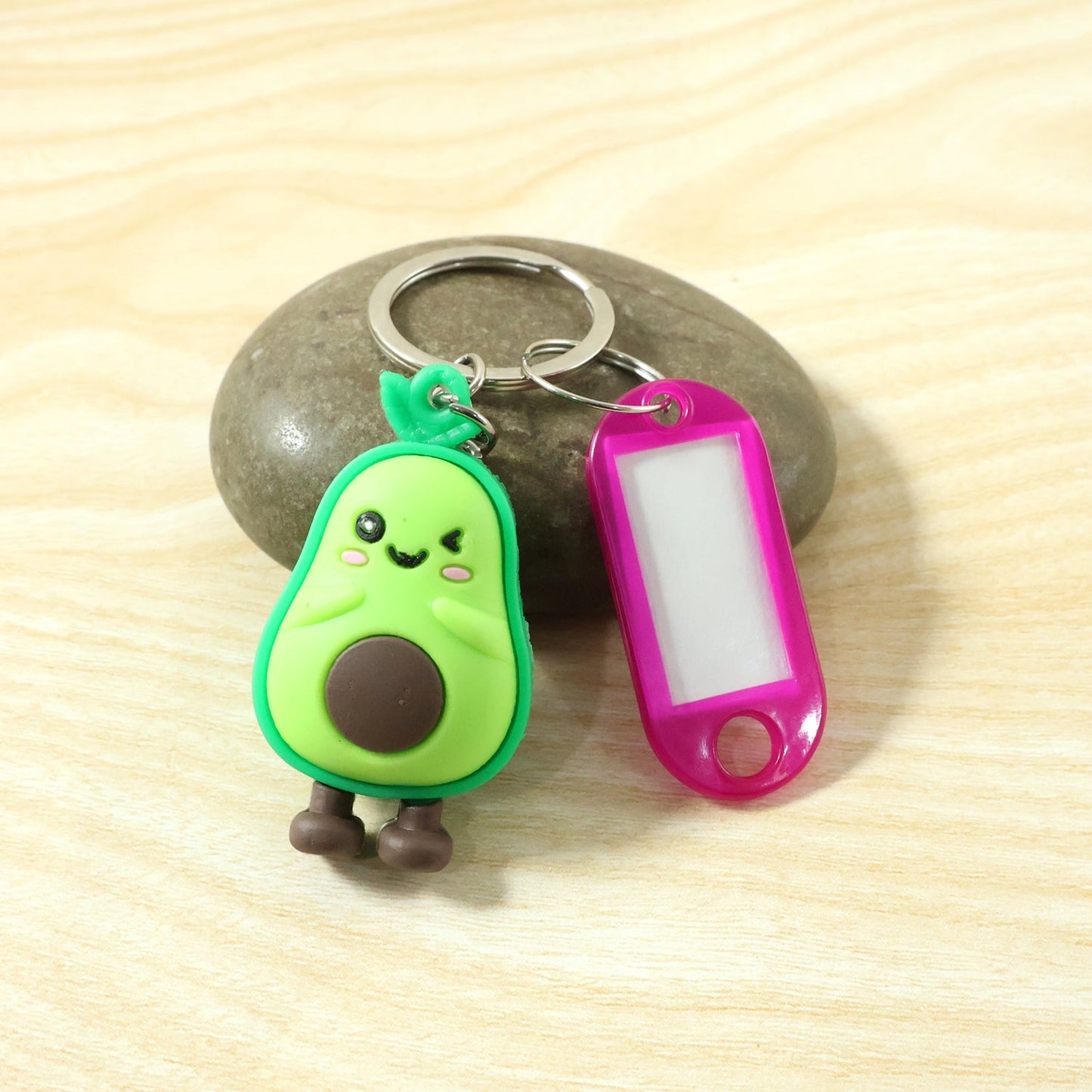 Close-up of cute figure keychain featuring label tag for identification