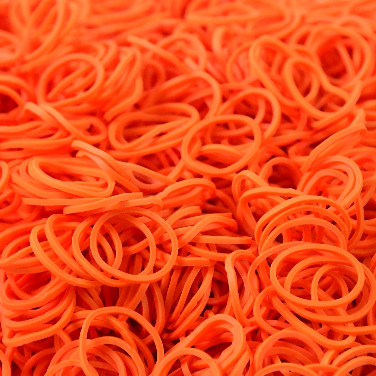 Orange elastic rubber bands closeup showing texture
