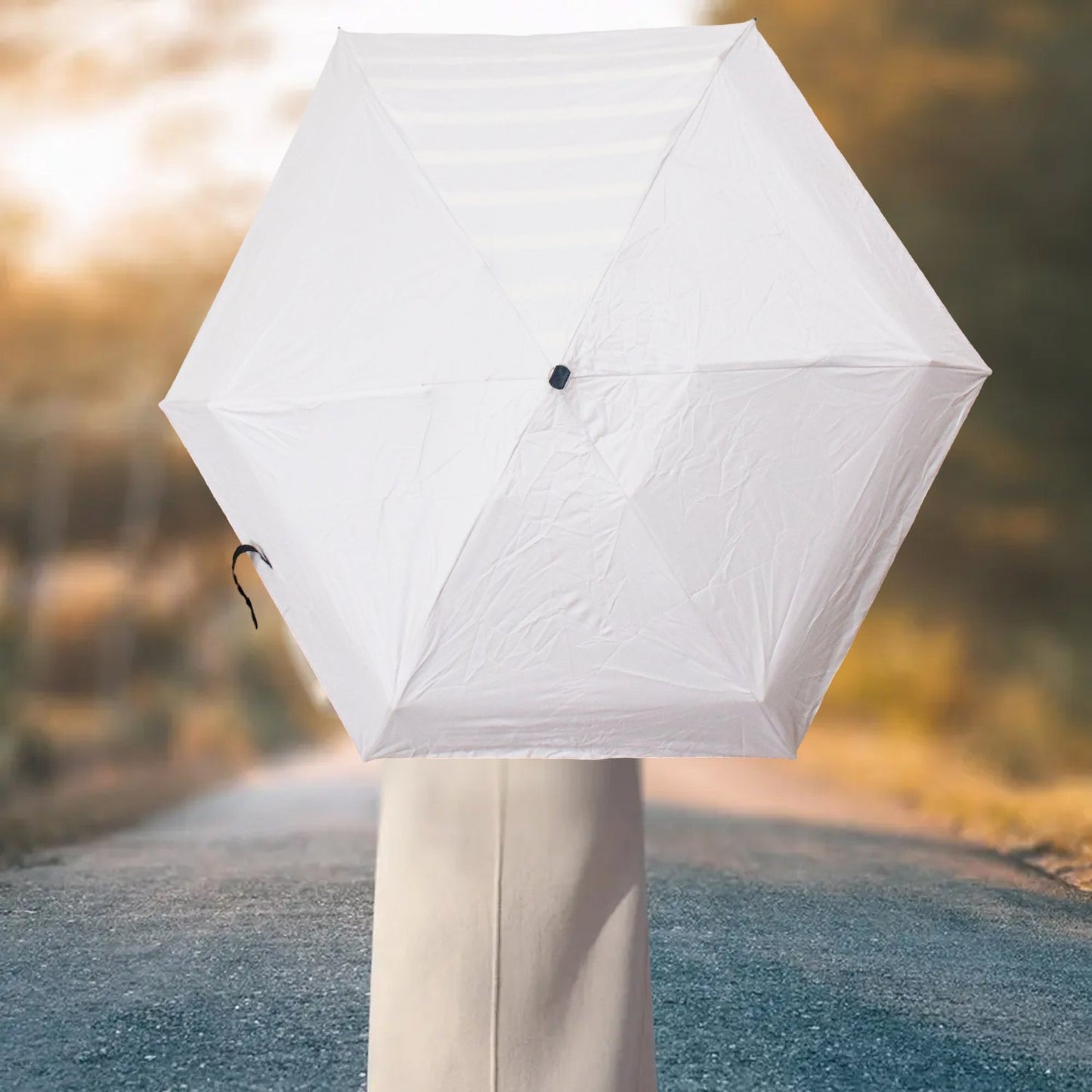 Sleek 3-fold DrizzlePro umbrella in its compact, closed form for easy carrying.