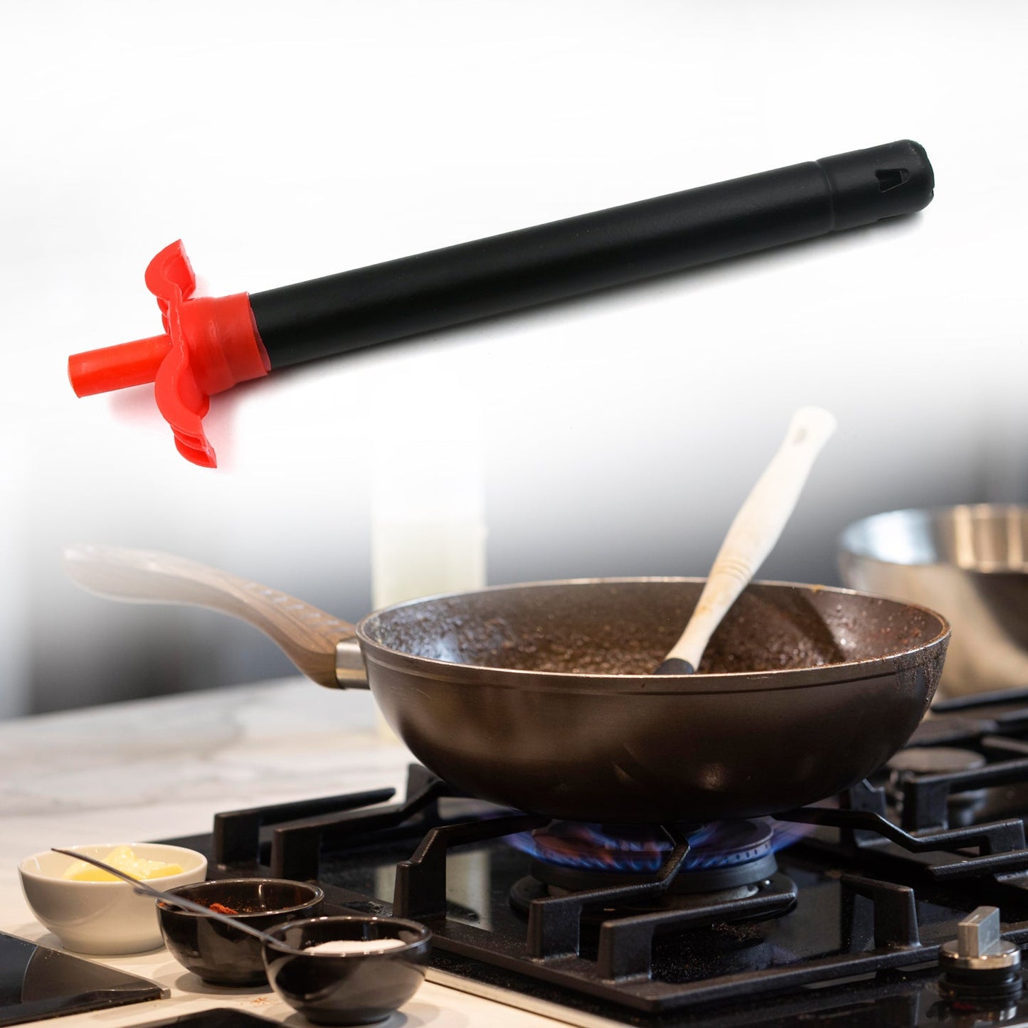 Stainless steel gas lighter standing upright on a kitchen counter.