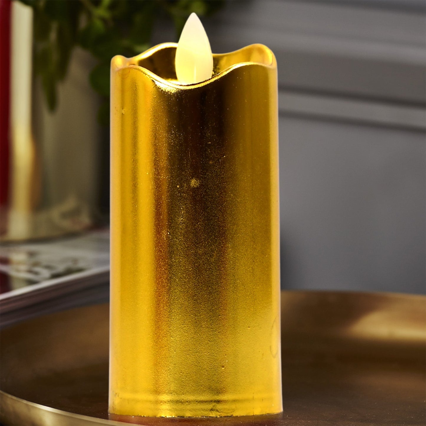Detailed view of the realistic flame on a golden flickering LED candle.