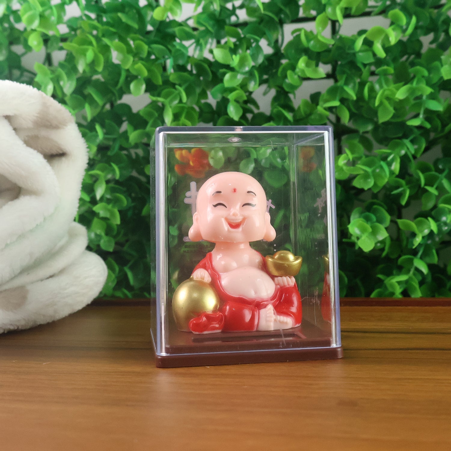 Side view of the solar-powered nodding Buddha statue, designed for positive energy in your car.