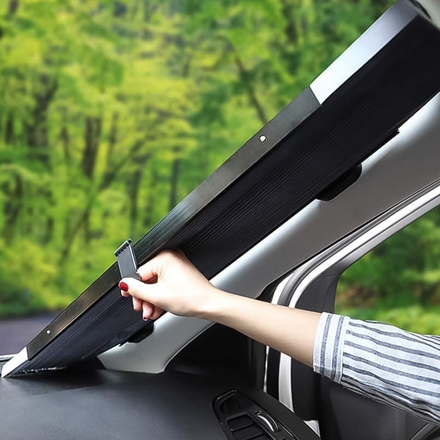 Car interior showcasing the long retractable sunshade in use.