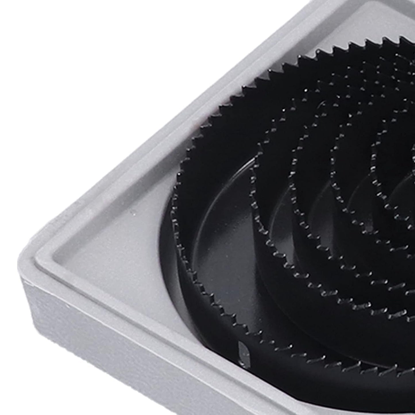 Multiple carbon steel hole saws of different diameters, highlighting the range available in the kit.