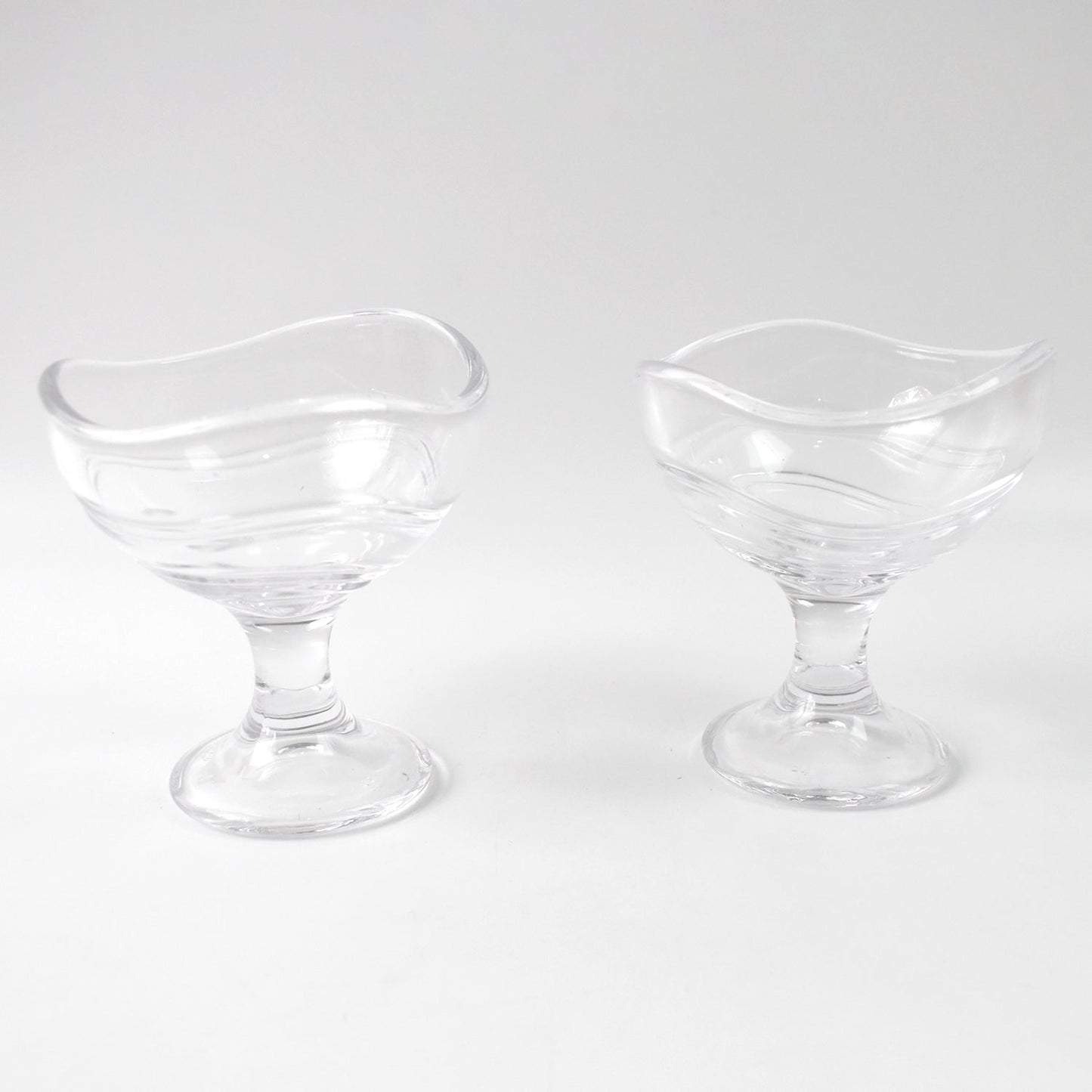 Clear glass dessert bowl highlighting its sturdy footed base.