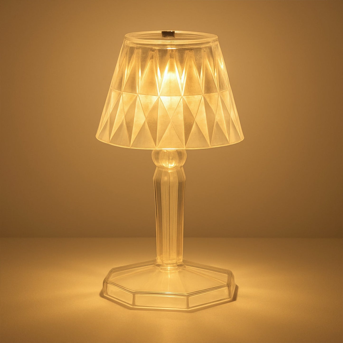 A detailed view of the acrylic crystal table lamp on a wooden surface.