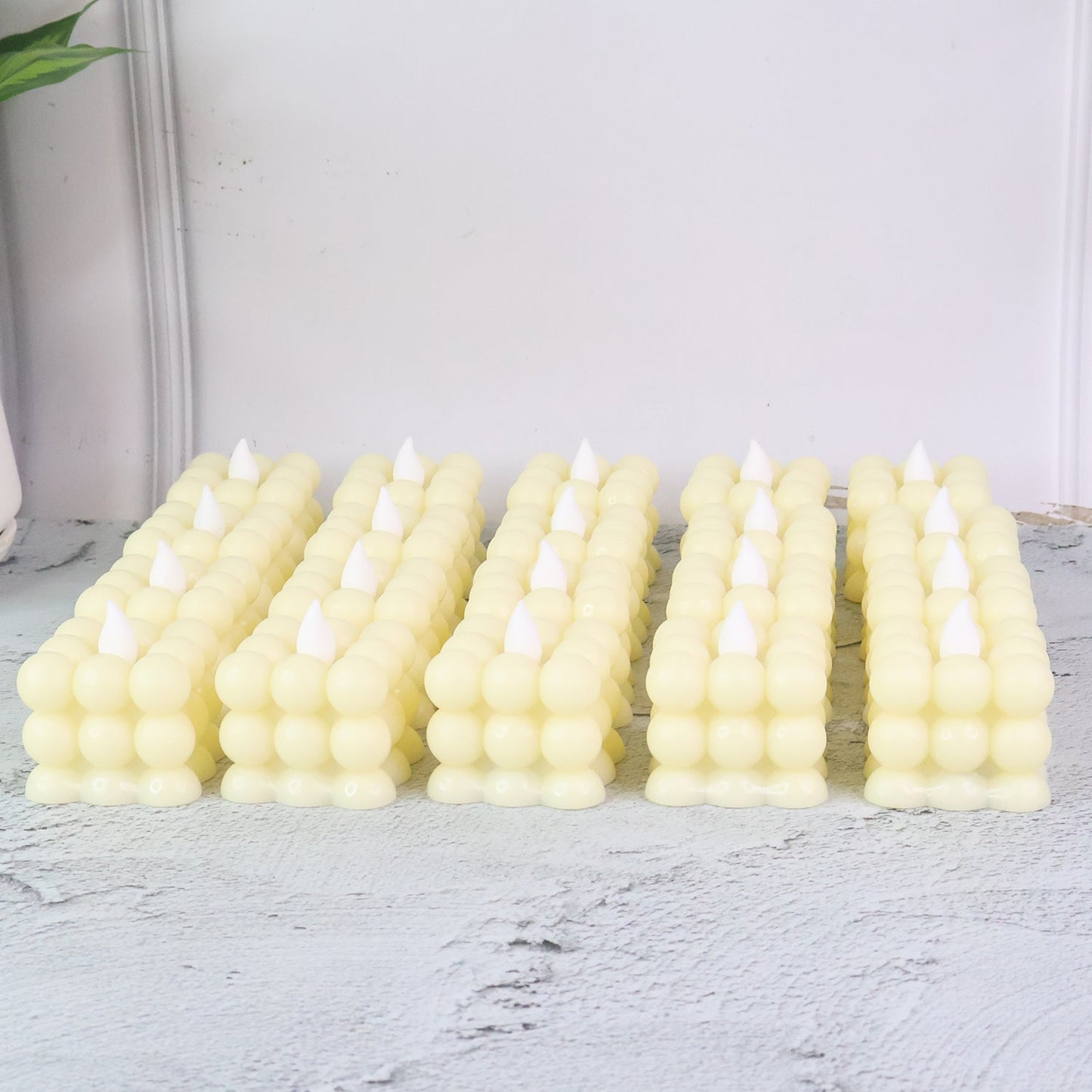 Close-up of decorative LED flameless cube candle showing bubble design and warm glow