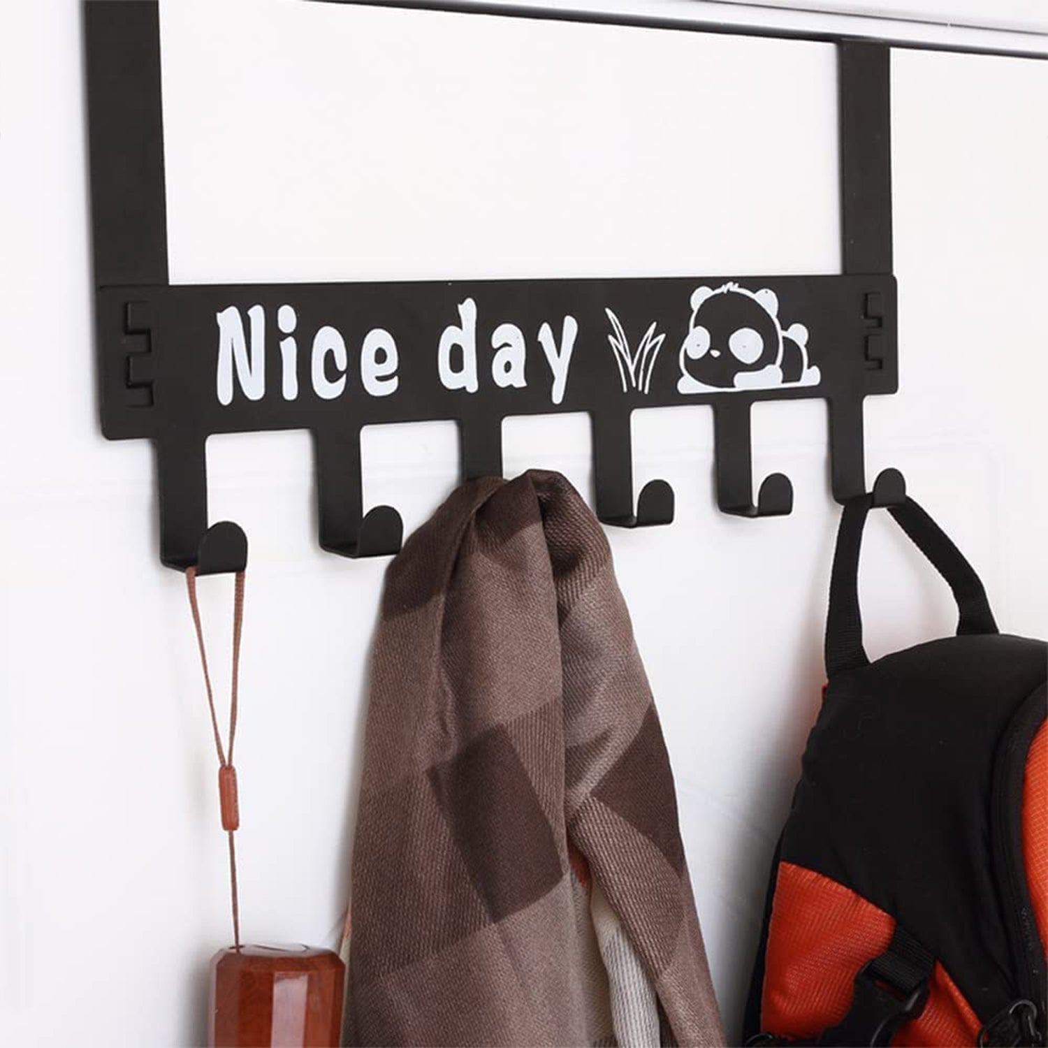 Over door hook rack organizing various clothing items and accessories neatly.