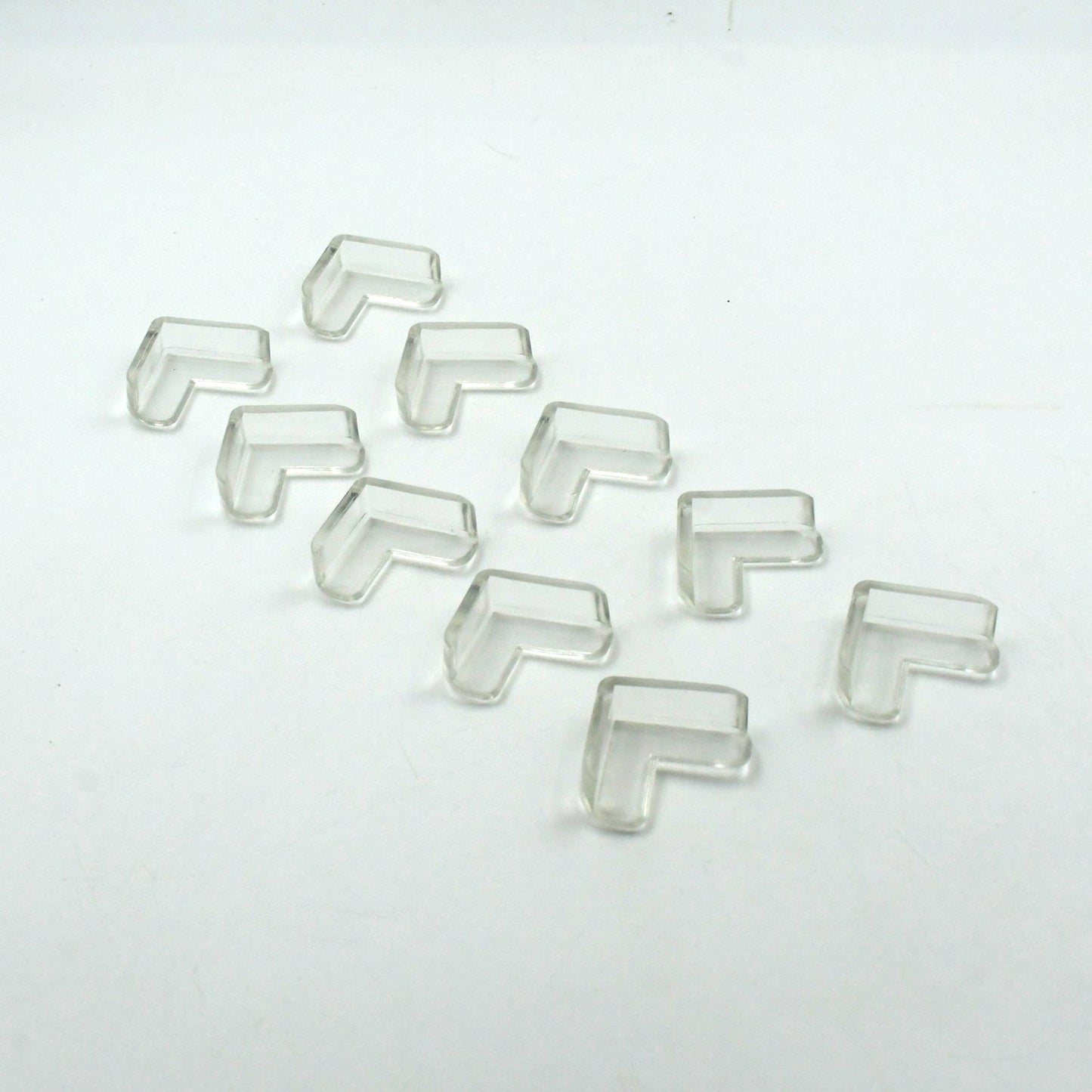 Multiple clear corner guards effectively applied to sharp furniture edges in a home.
