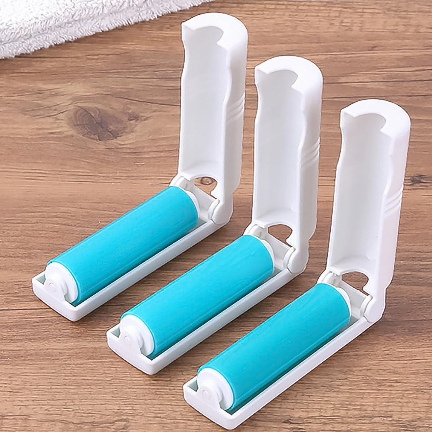 The reusable lint roller efficiently removing pet hair from a beige sofa cushion.
