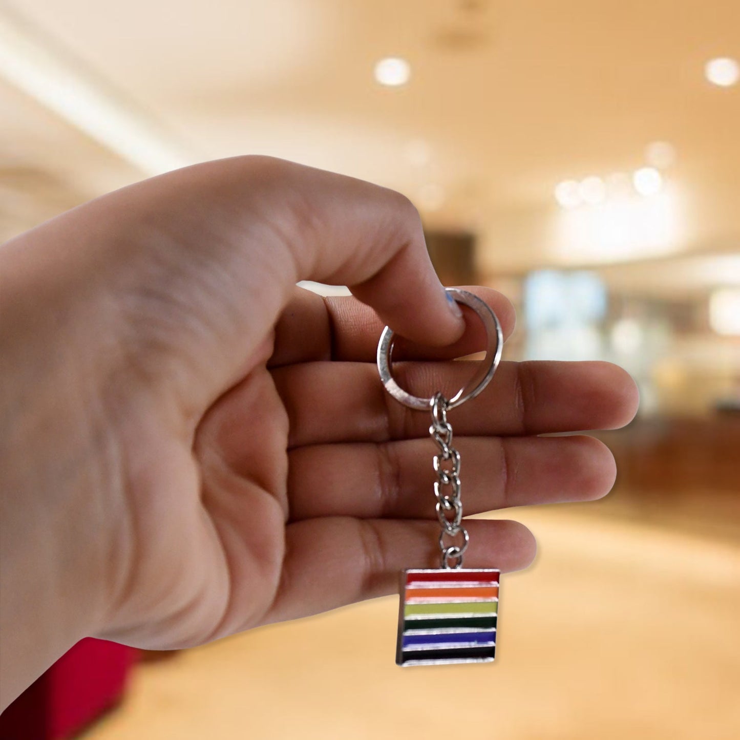 Rainbow metal keychain angled view displaying vibrant texture