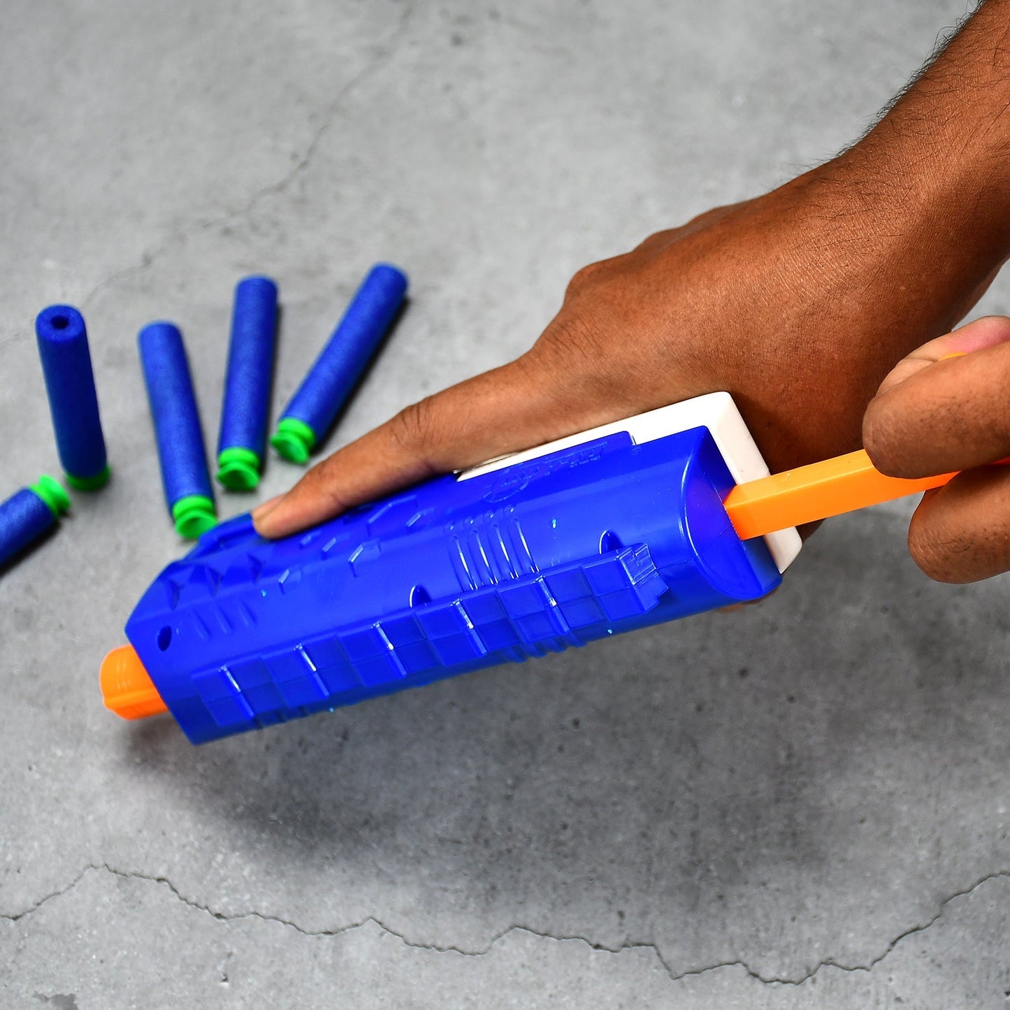 Child aiming the Aditi foam blaster gun at a target.