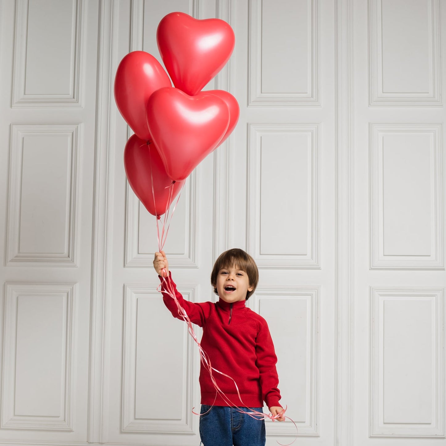 A collection of inflated heart shaped balloons ready for a party.