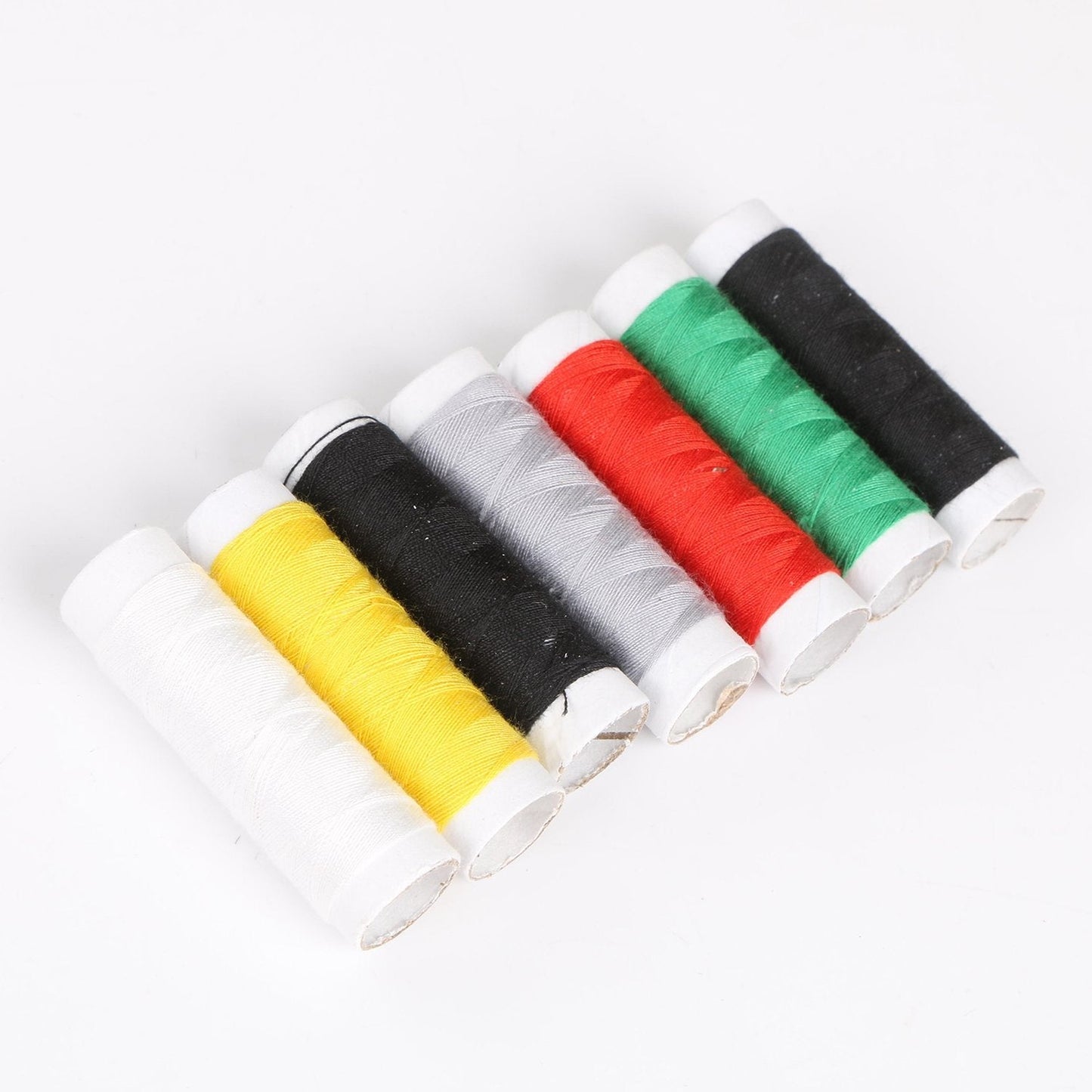 Essential sewing kit components including a needle threader and cutter.