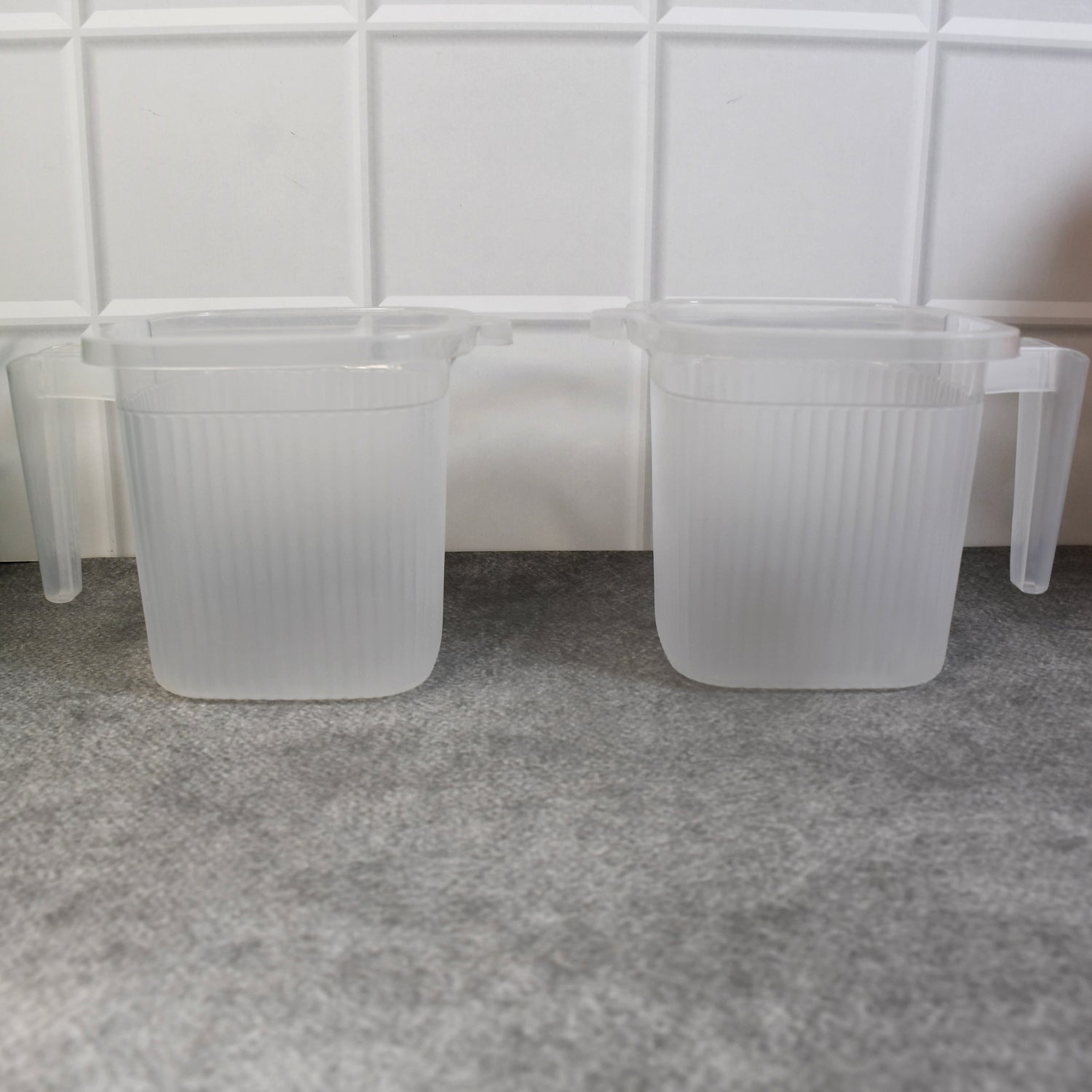 Overhead view of the robust plastic mugs, showcasing their wide opening for easy cleaning.