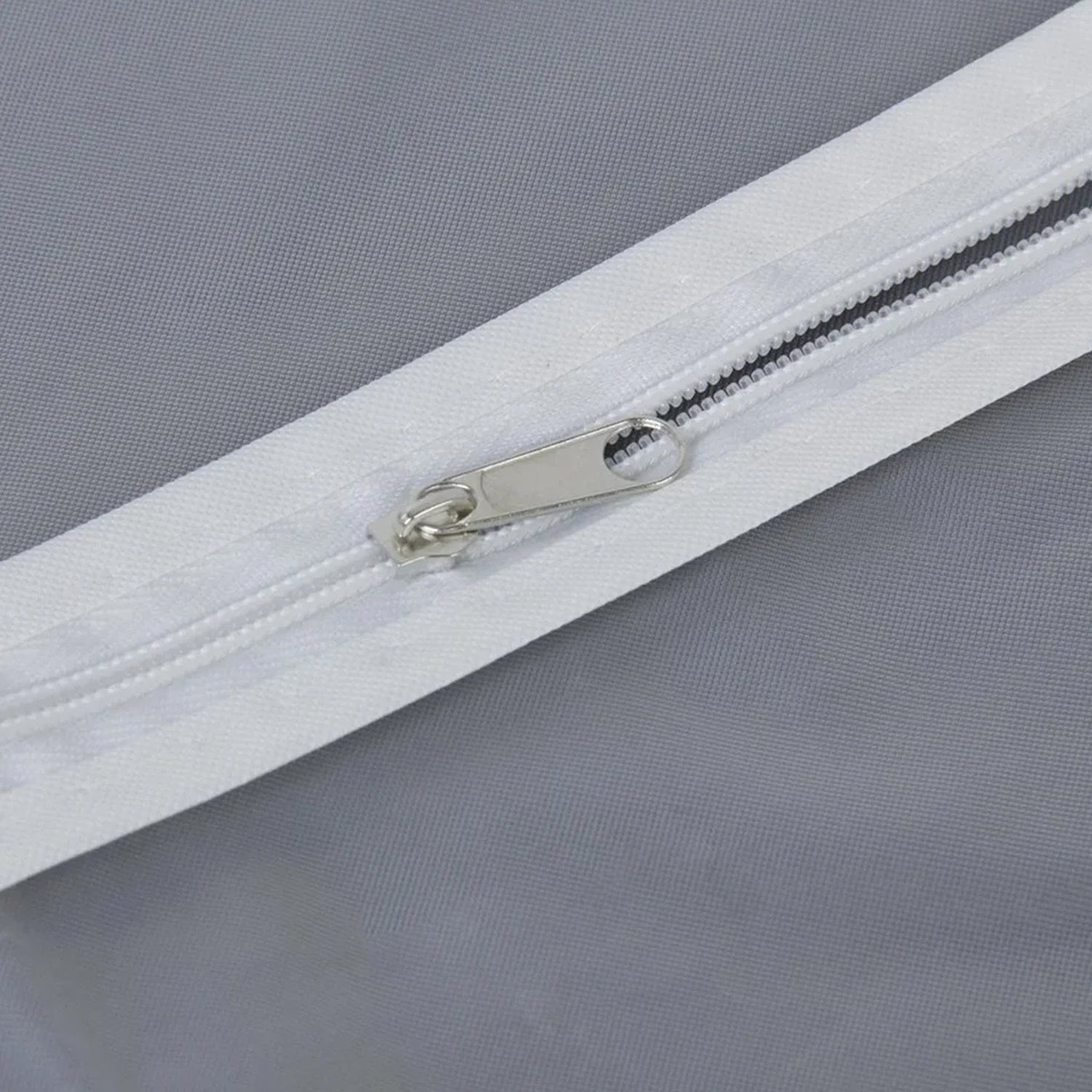Closeup of full-length zipper on suit cover with breathable fabric.