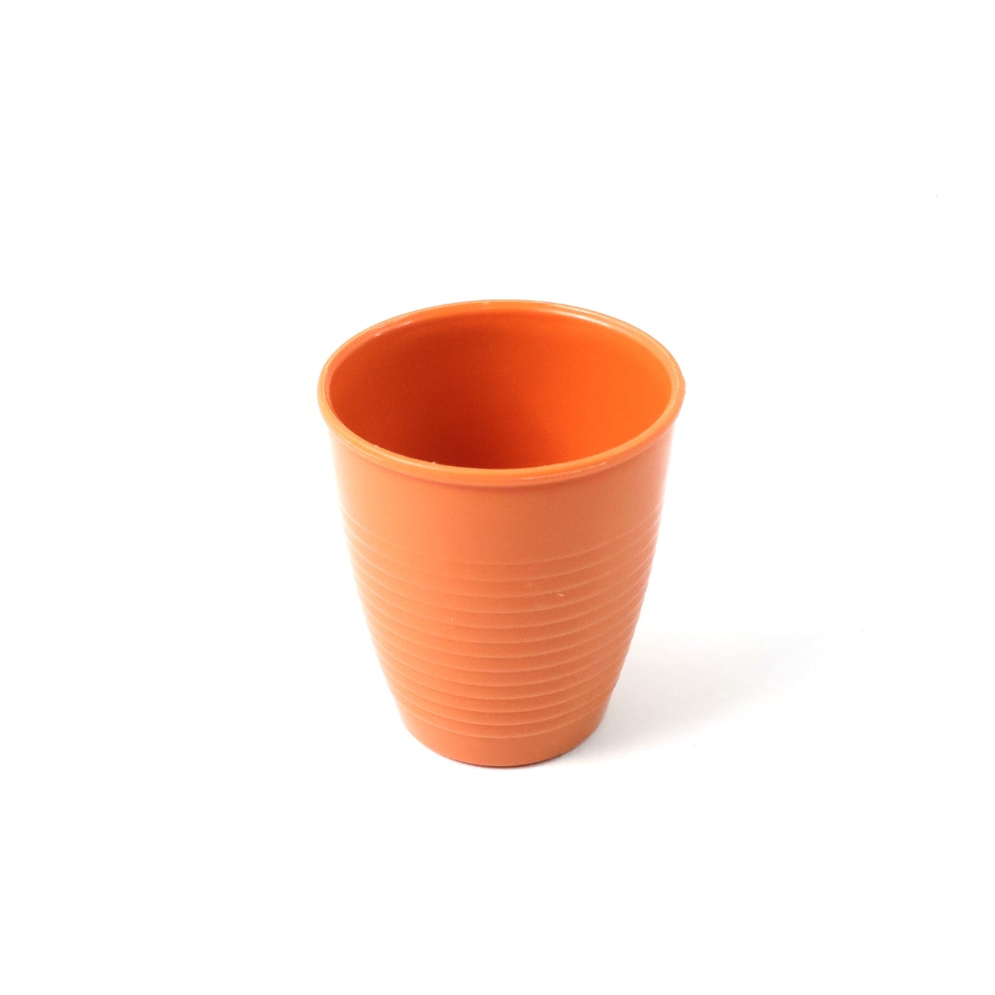 Side view of compact plastic small drinking cup on white