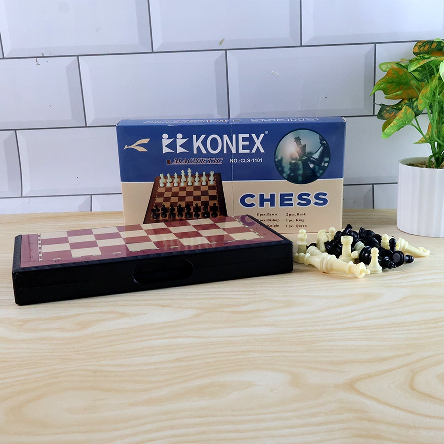 Foldable chess board displaying magnetic plastic pieces in play