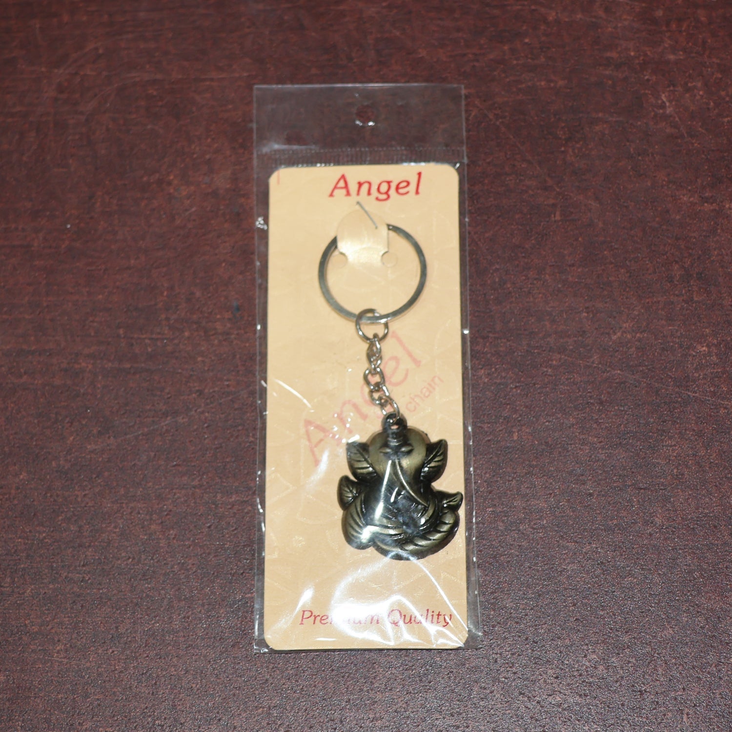 Ganesh Face Antique Black Metal Keychain placed on plain background for clear visibility