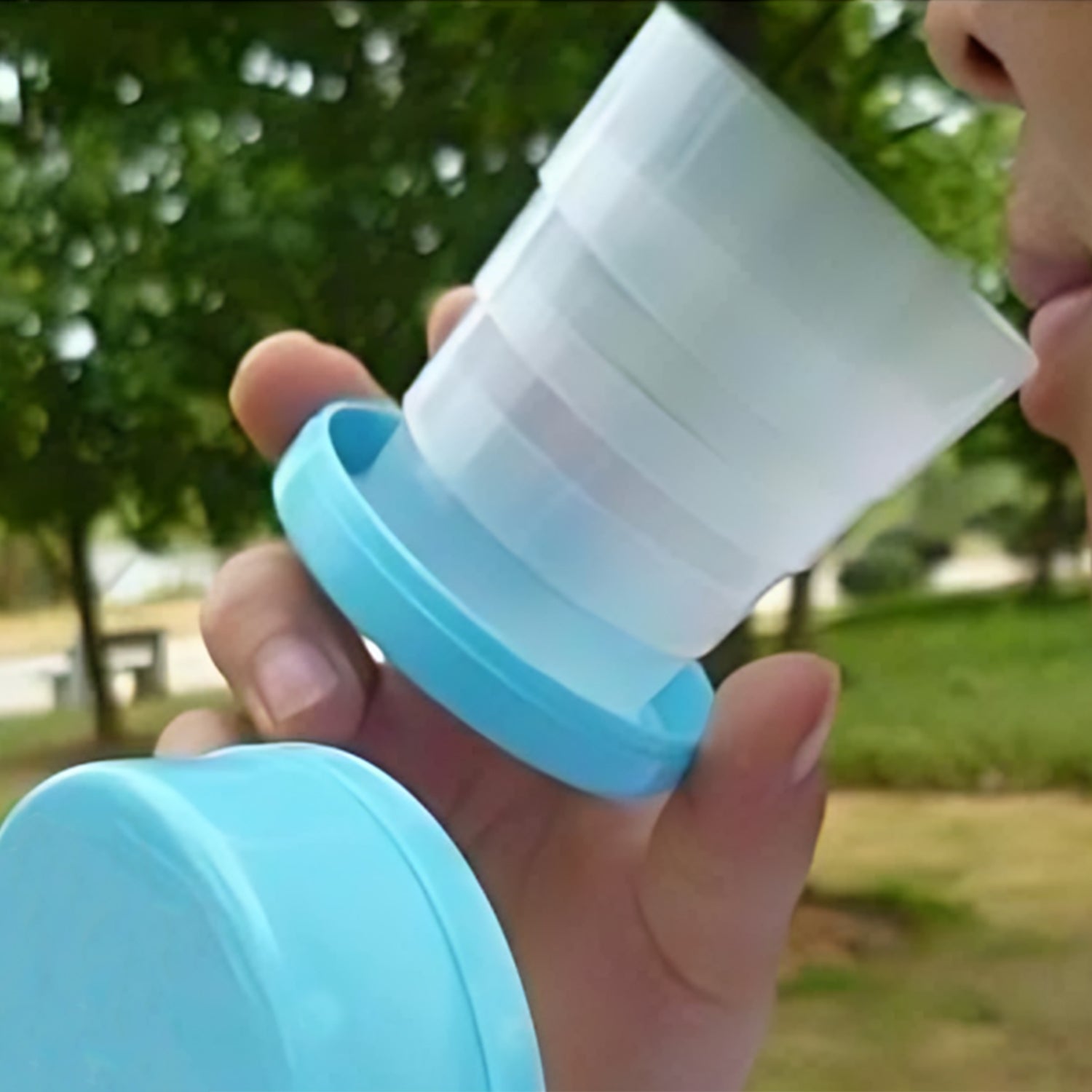 The reusable folding travel cup fully expanded, ready for use with a drink.