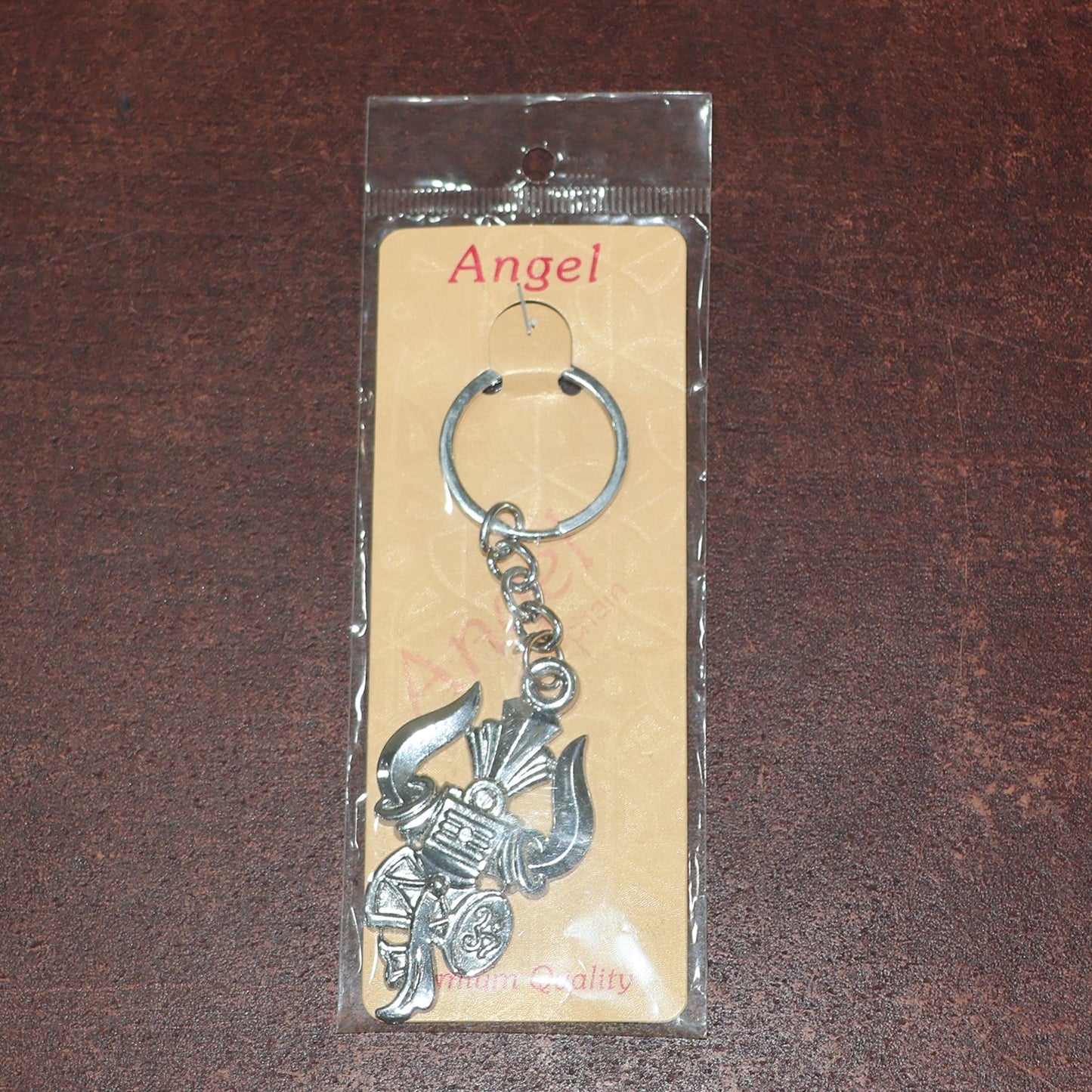 Metal keychain displaying detailed craftsmanship of Trishul and Damru symbols
