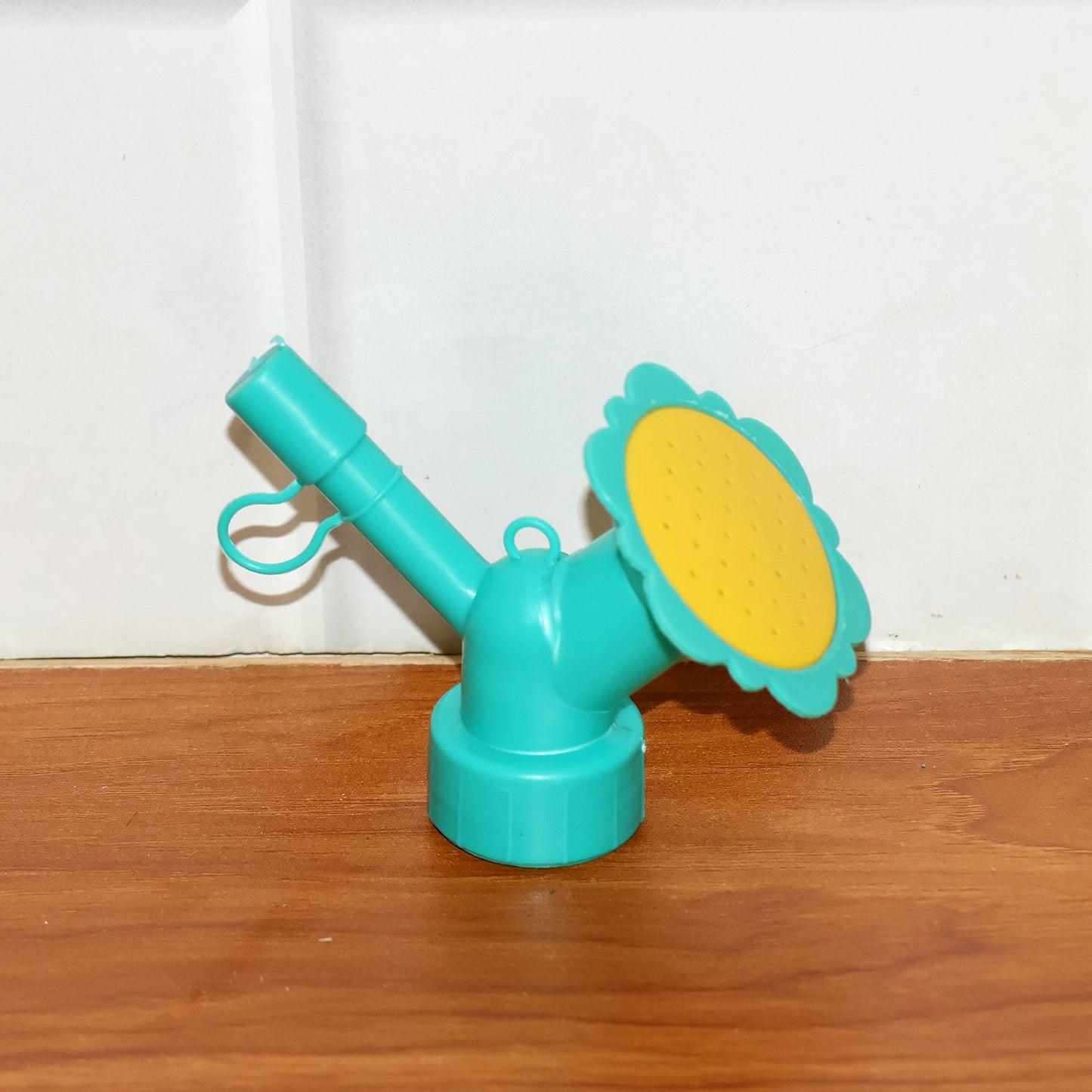 Bottle sprinkler head nozzle showing compact, portable gardening accessory