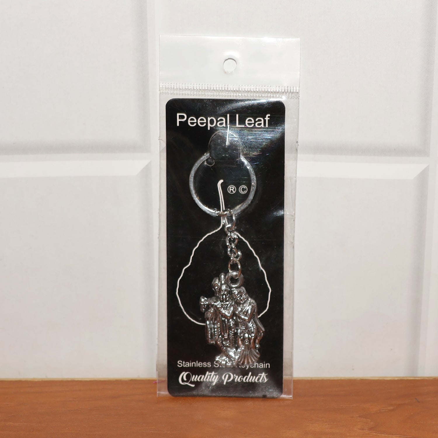 Back view of Radha Krishna metal keychain showing craftsmanship