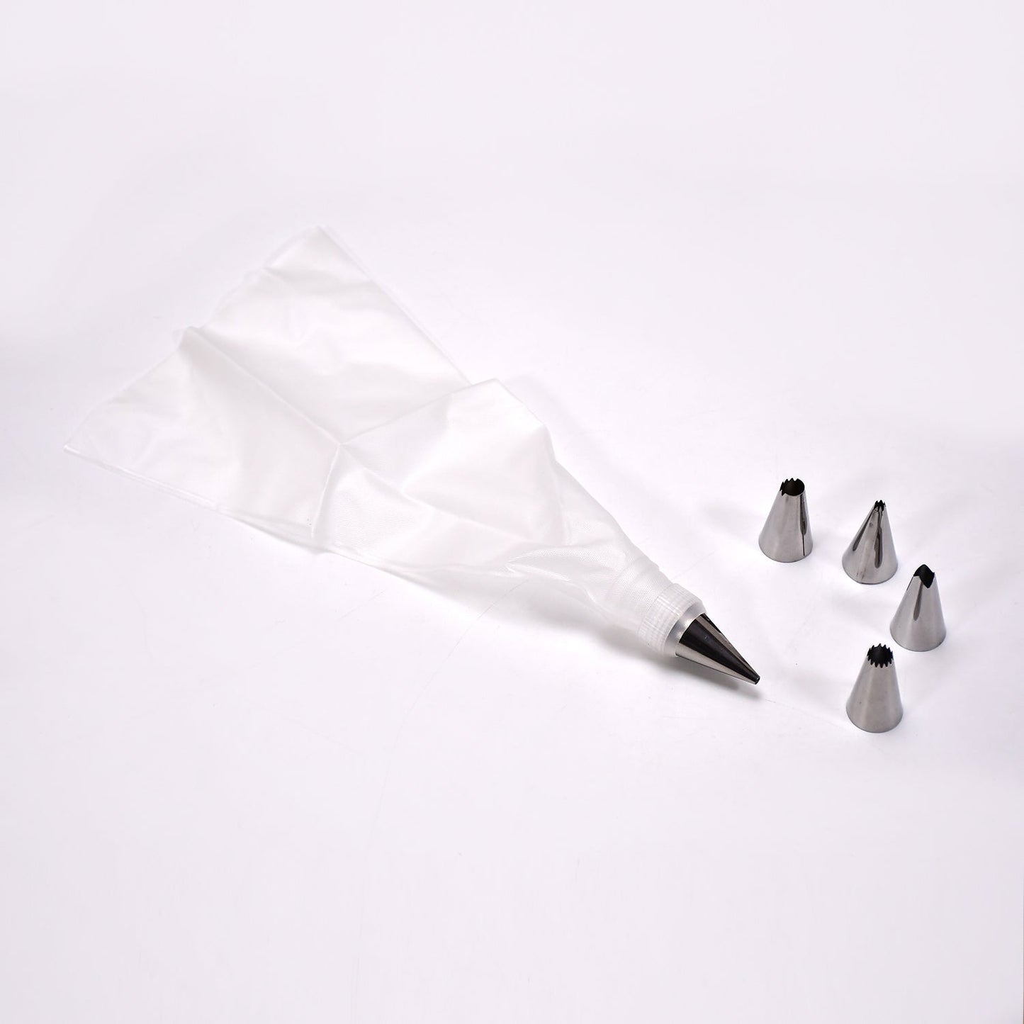 A collection of stainless steel piping nozzles for intricate cake and cupcake decorations.