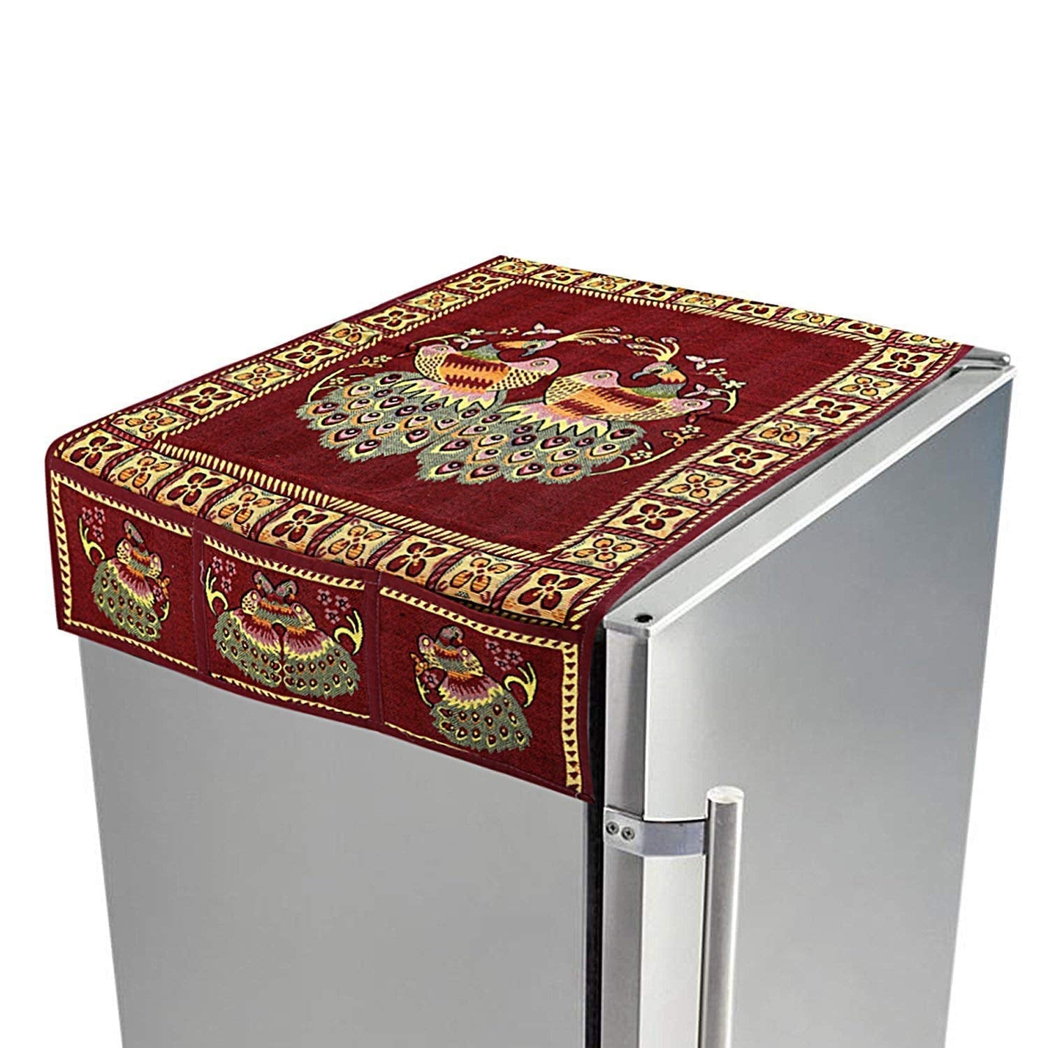 Cotton fridge top cover with peacock design and side pockets on a refrigerator.