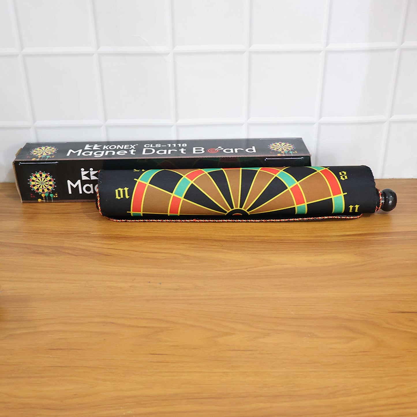 Closed roll-up dartboard in travel tube with included safety darts